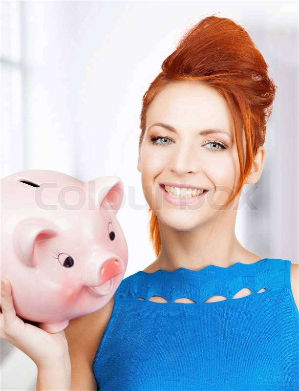 Lovely woman with big piggy bank, stock photo