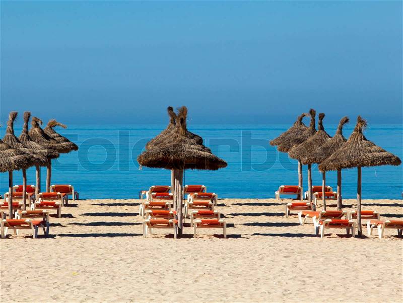 Tropical beach scenery with parasol and deck chairs. umbrella and deck chairs, stock photo