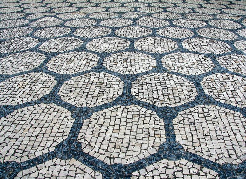 Clear stone blocks pavement texture with a dark central hexagons motive for background, stock photo