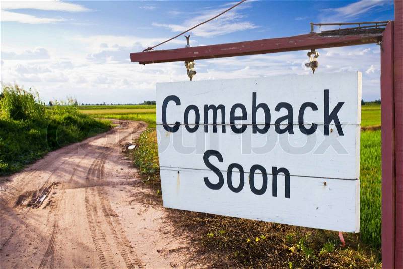 Come back soon wood sign with country road, stock photo
