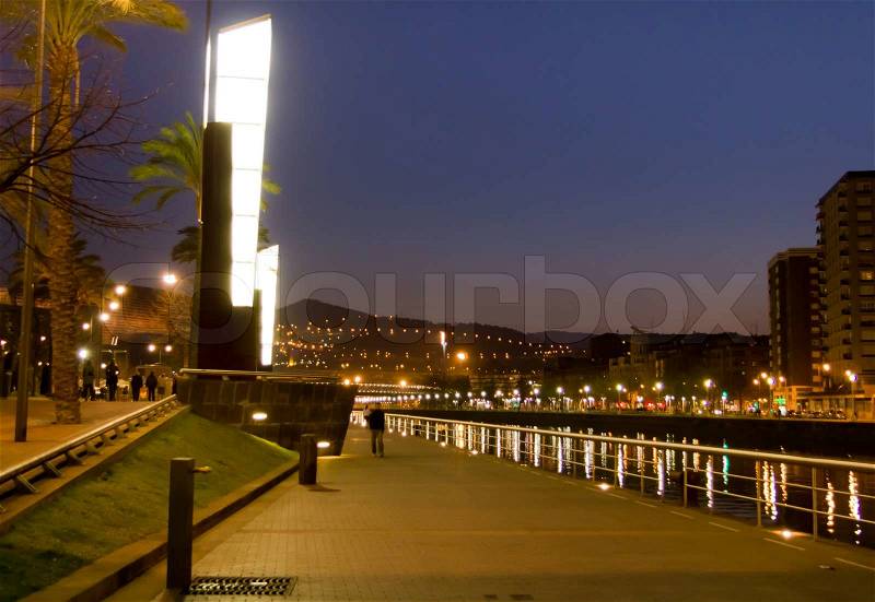 Nightview of Nervión river promenade and the original lamppost, in Bilbao, Spain, stock photo