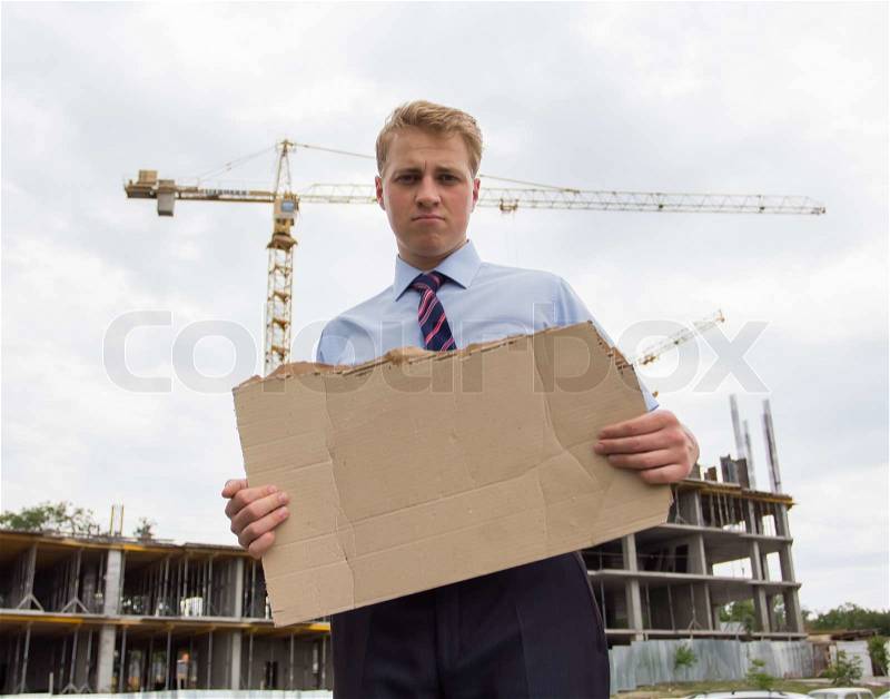 Young man holding a poster, stock photo