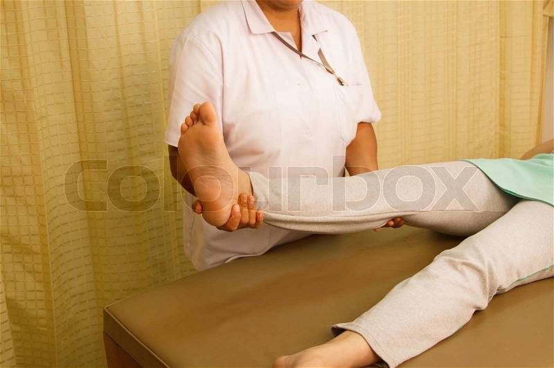 Physiotherapist treating quadriceps muscle,Rehabitation for muscle weakness, stock photo