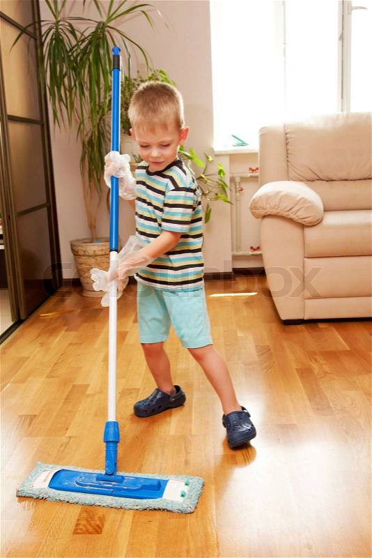 Little boy cleaning room Mother\'s helper, stock photo