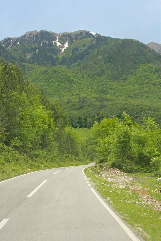 Asphalt road to mountains in Montenegro, stock photo