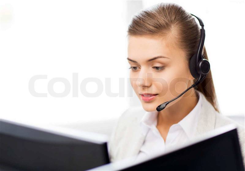 Picture of friendly female helpline operator with headphones, stock photo