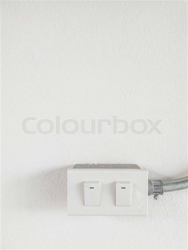 Light switch on white wall, stock photo