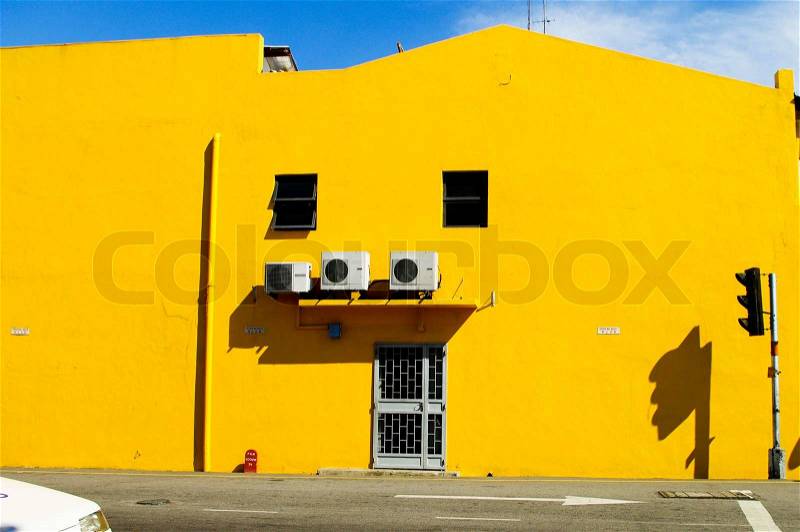 Yellow building wall with door and window on the road. Melaka. Malaysia, stock photo