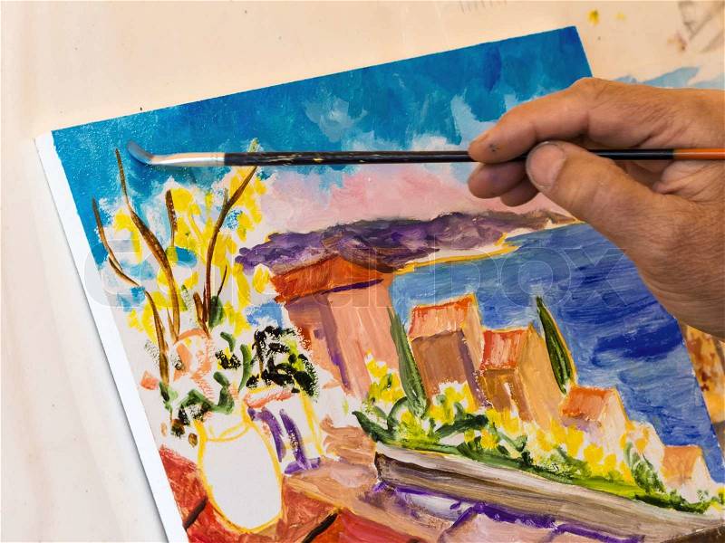 Painting with water colors. painter painting a landscape, stock photo