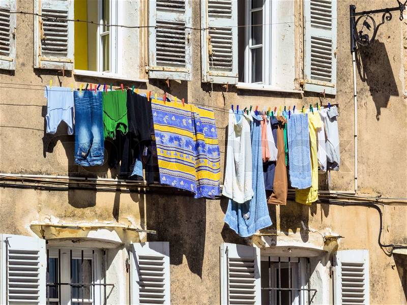 Washing on the line in front of a window, stock photo