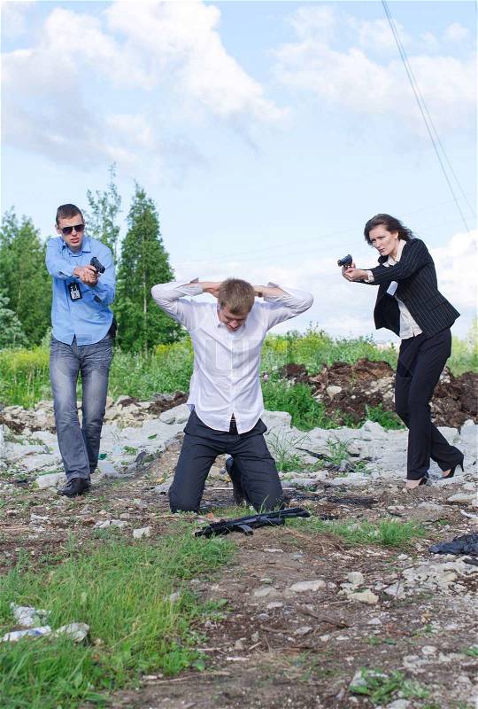 Two FBI agents conduct arrest of an offender, stock photo