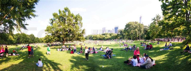 NEW YORK CITY - JUN 15: Locals and tourists relax on the beautiful Central Park, June 15, 2013 in NYC. There are more than 21,500 trees growing in the park, according to the Central Park Conservancy, stock photo