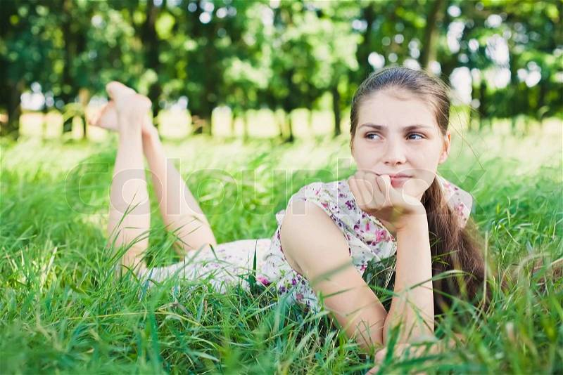 Young woman lying on the grass, stock photo