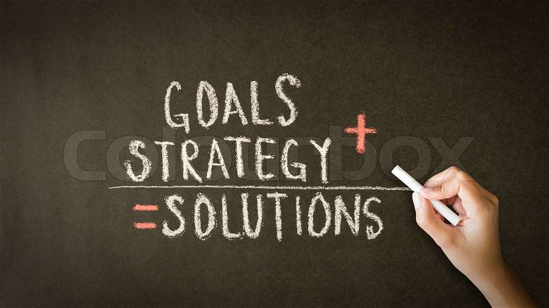 A person drawing and pointing at a Goals, Strategy, Solutions chalk drawing, stock photo