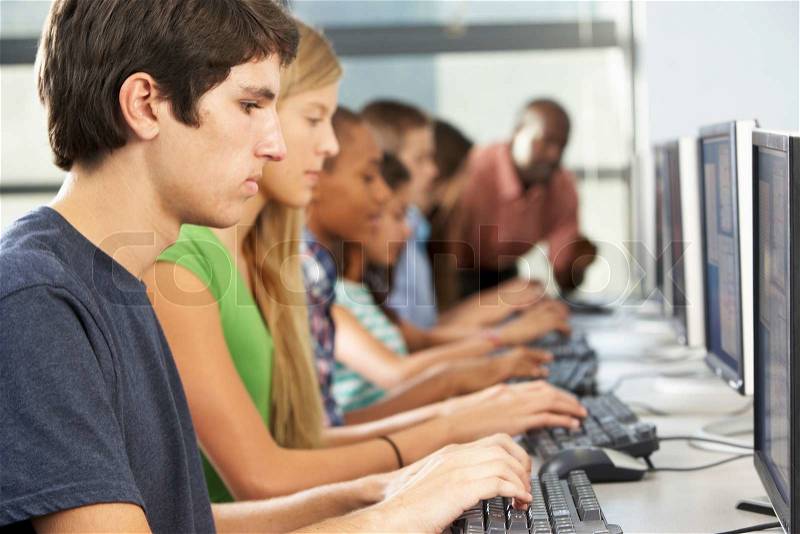 Group Of Students Working At Computers In Classroom, stock photo