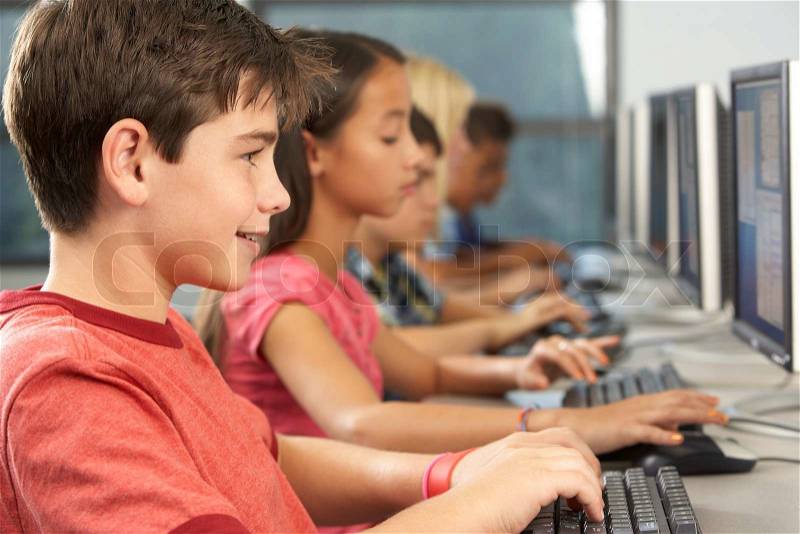 Elementary Students Working At Computers In Classroom, stock photo