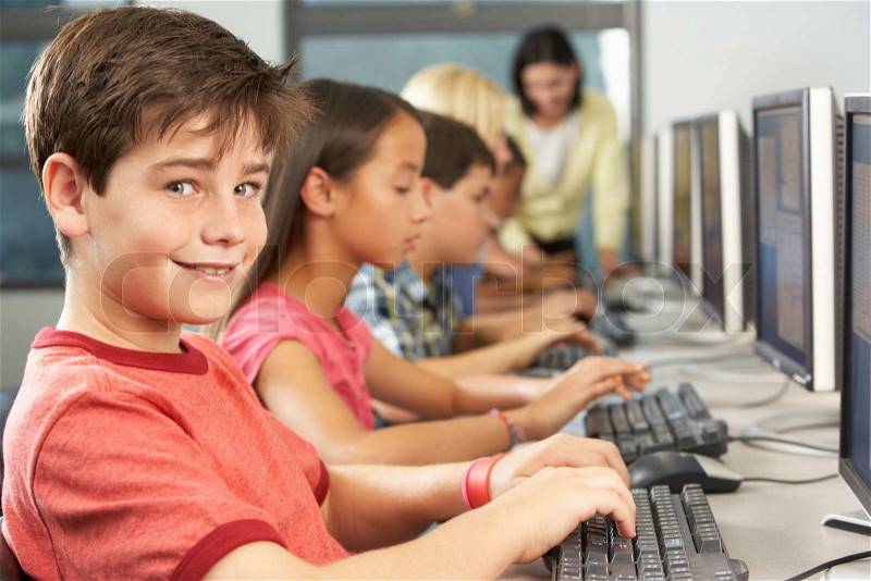Elementary Students Working At Computers In Classroom, stock photo