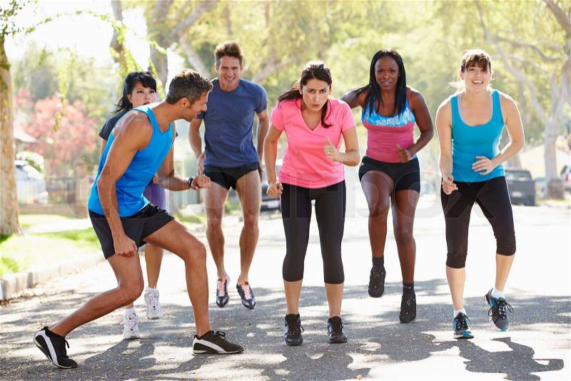 Group Of People Exercising Street With Personal Trainer, stock photo
