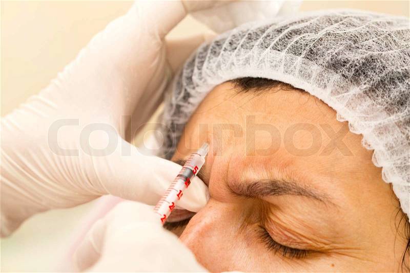 Cosmetic treatment with botox injection in a clinic, stock photo