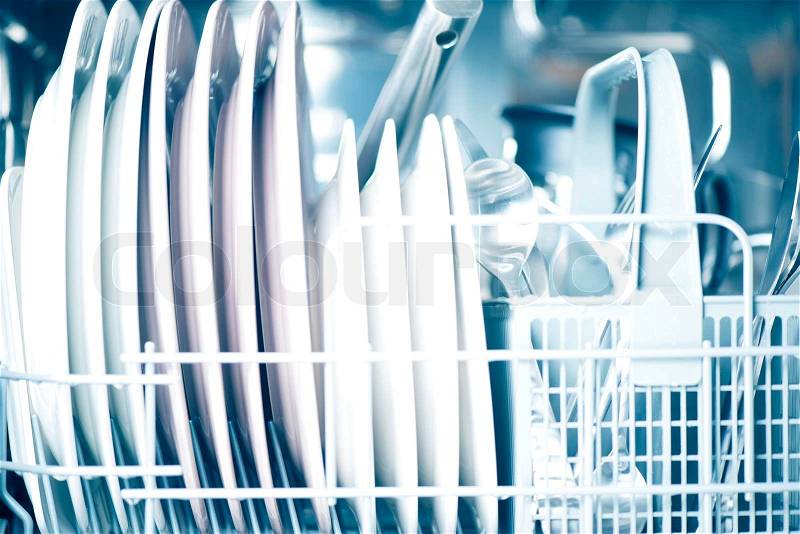 Clean dishes in dishwasher, stock photo