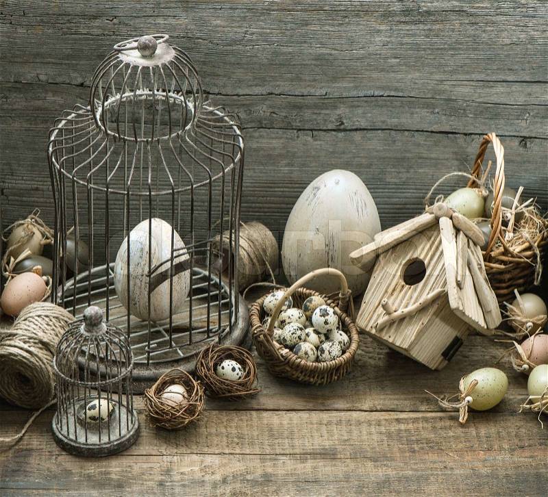 Stock image of 'vintage easter decoration with eggs, birdhouse and birdcage. nostalgic still life home interior. wooden background'