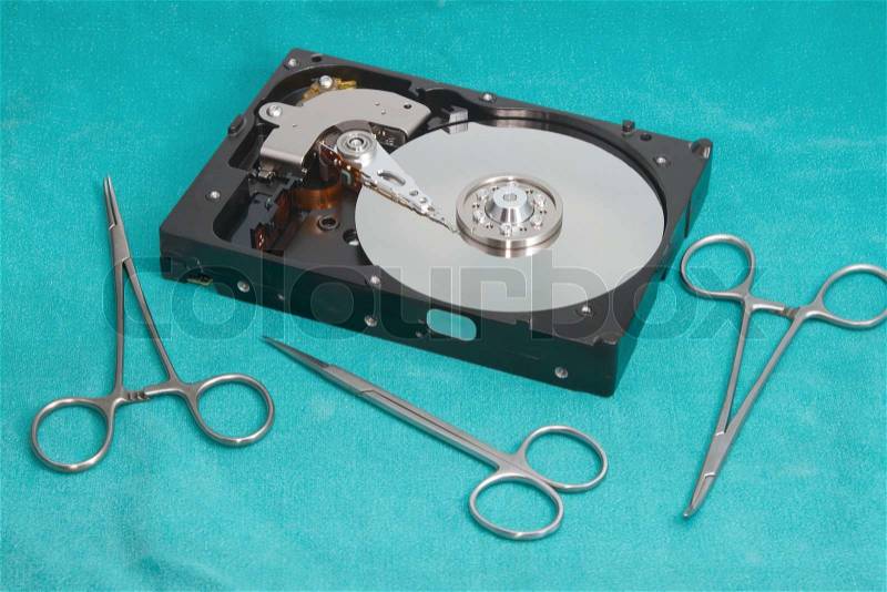 Hard drive with surgery tool ,Hard drive on repairs data recovery concept, stock photo