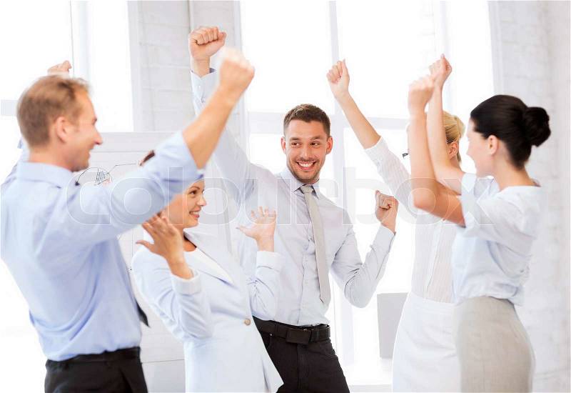Picture of happy business team celebrating victory in office, stock photo