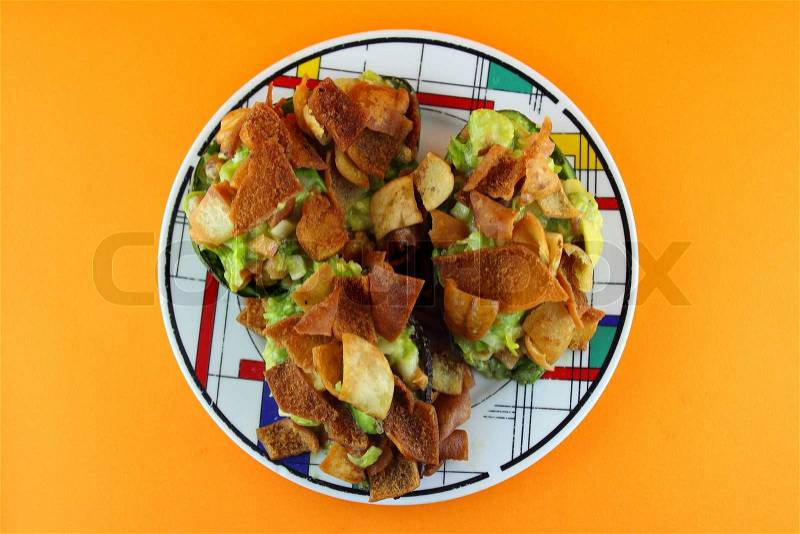 Healthy Avocado Salad stuffed with Crispy bread, tomato and salsa, stock photo