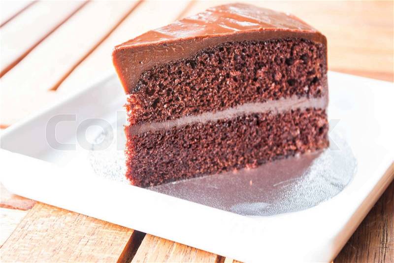 Part of chocolate chiffon cake on white dish, stock photo