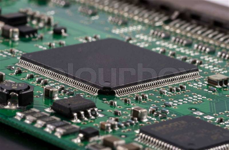 Green Electrical Circuit Board with microchips, conductors, and transistors, stock photo