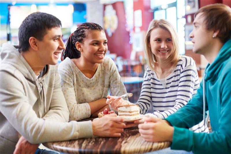 Image of teenage friends spending time in cafe, stock photo
