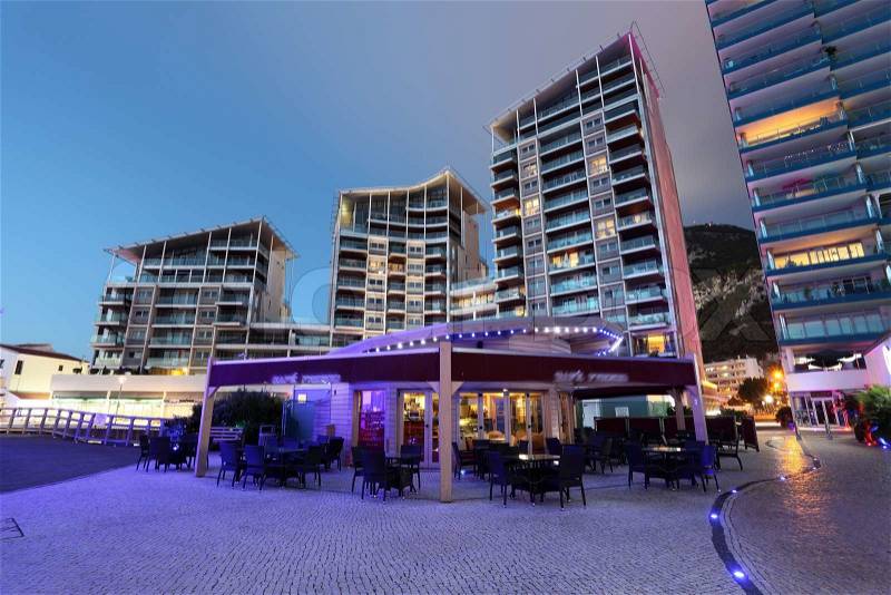 Building in Ocean Village marina at night, Gibraltar, stock photo