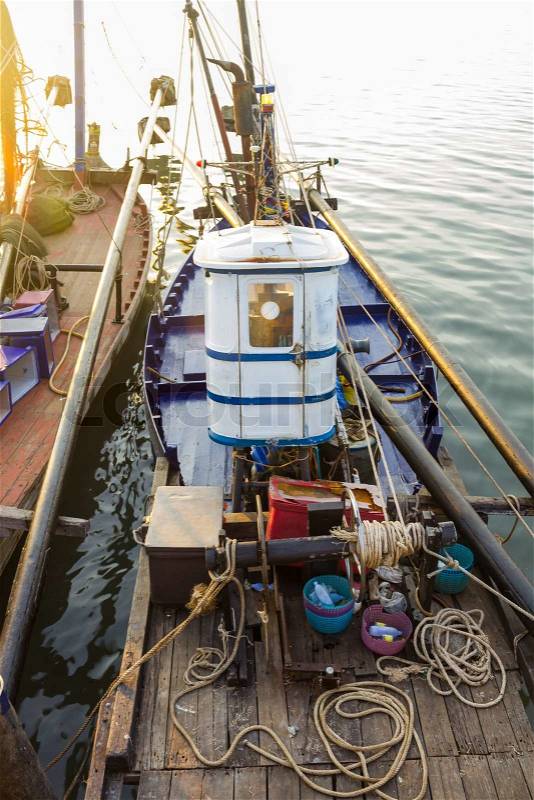 Fishing boats getting ready to go out in the morning, stock photo