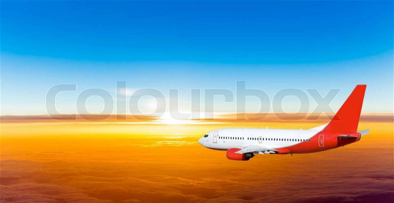 Airplane in the sky at sunset. A passenger plane in the sky, stock photo