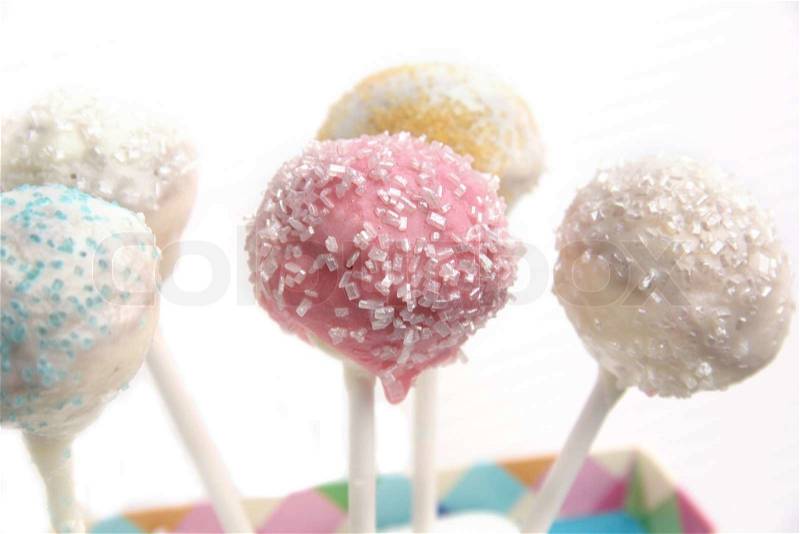 Cake pop treats with pastel icing and sugar sprinkles, stock photo