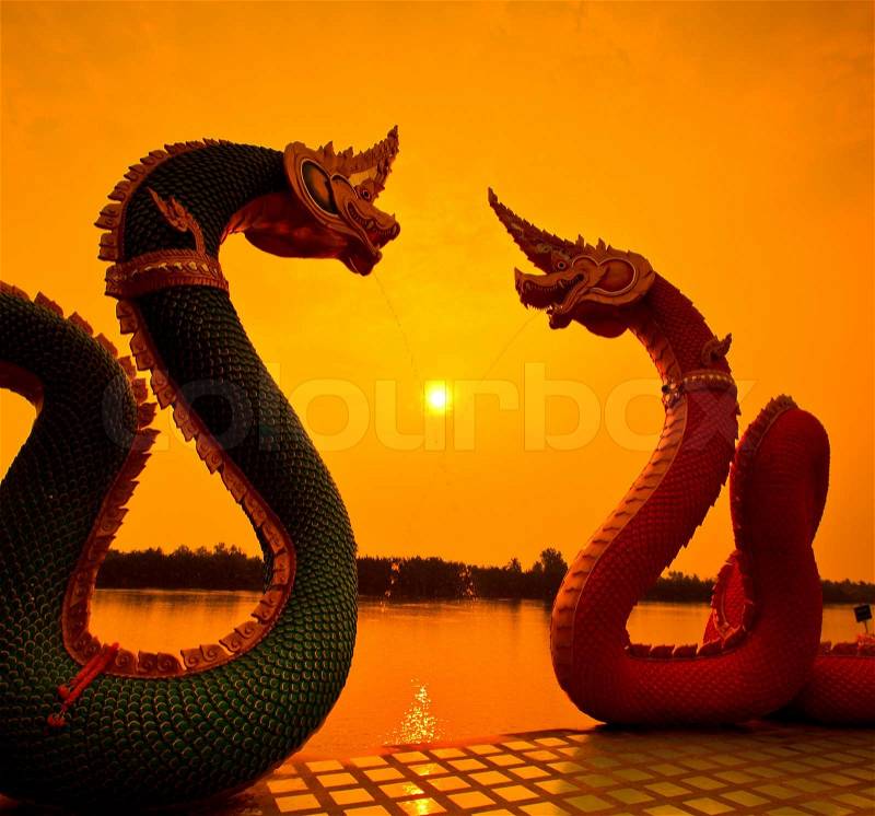 Silhouettes dragon and Naga statue protecting Thai temple, stock photo