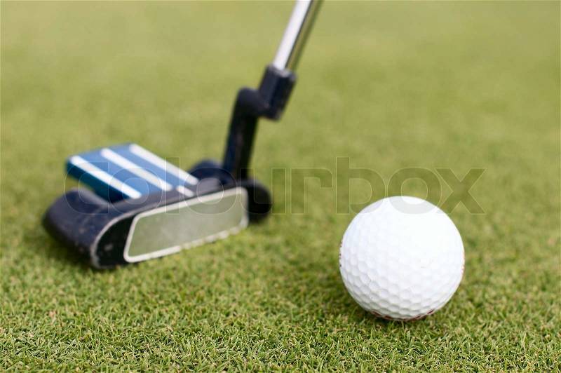Illustration of a golf ball on a green meadow, stock photo