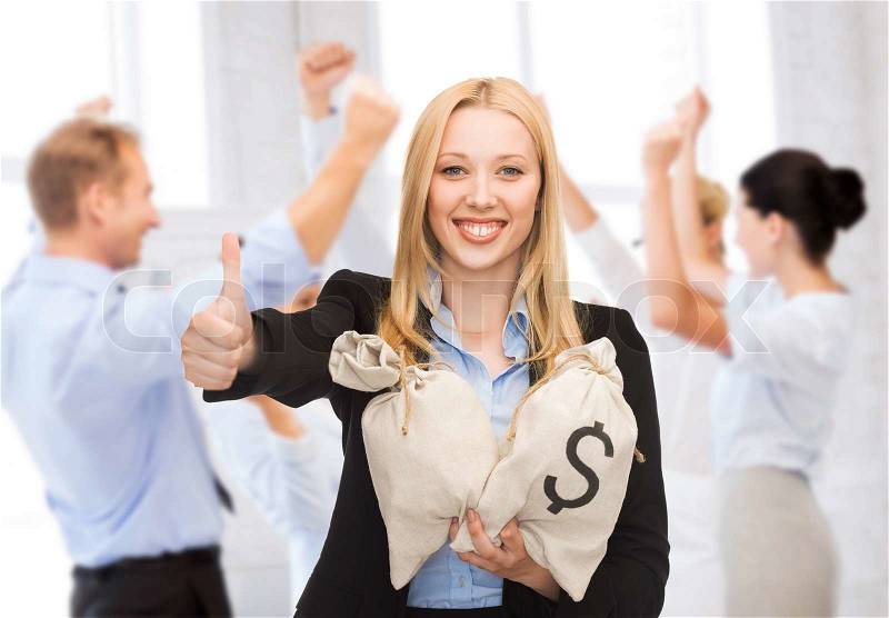 Business and money concept - businesswoman with money bags showing thumbs up, stock photo
