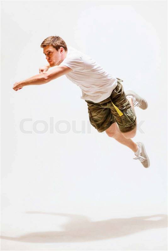 Sport and dancing concept - male dancer jumping in the air, stock photo