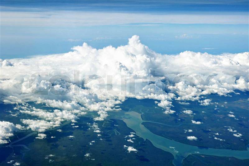 Aerial view of cloudy sky, river and forest, stock photo