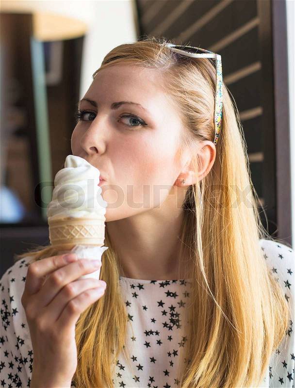 Woman eating ice cream, stock photo