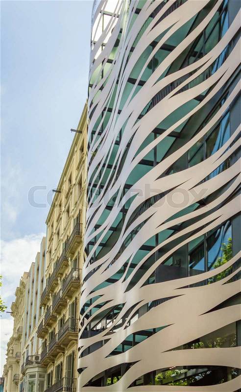 Facade of modern building, constructed with metal elements and waves forms, stock photo