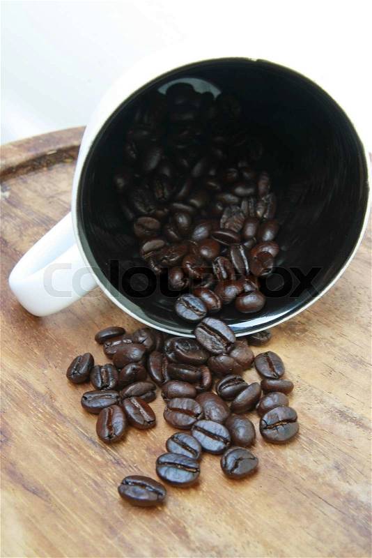 Coffee beans fall from cup , stock photo