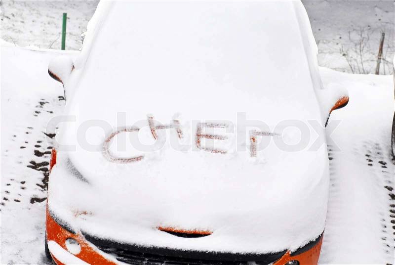Serbian cyrillic letters written on automobile covered by snow at winter outdoors, stock photo