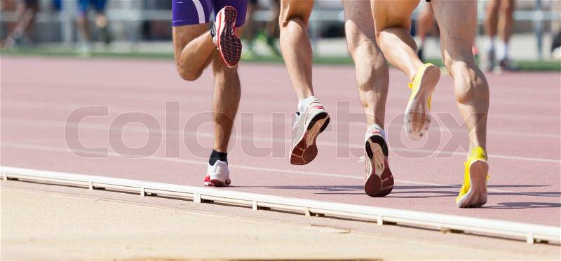 Closeup of legs of a track runner, stock photo