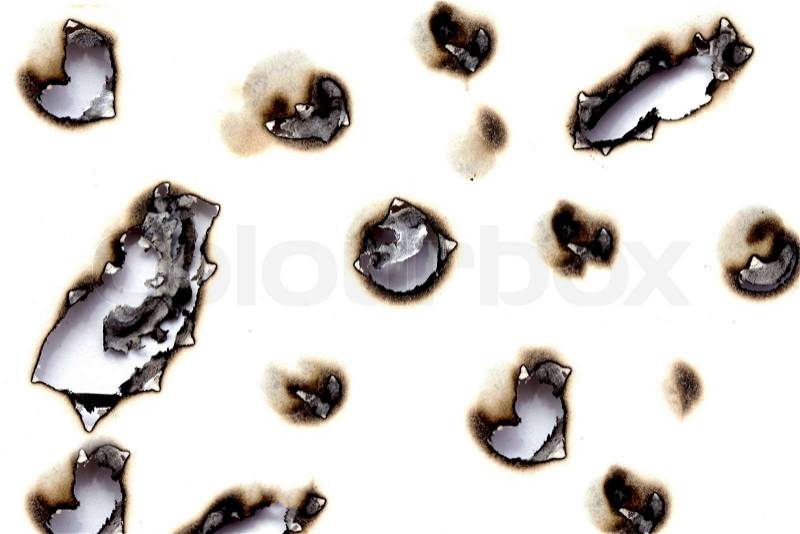 Collection of burnt holes in a piece of paper isolated on white background, stock photo