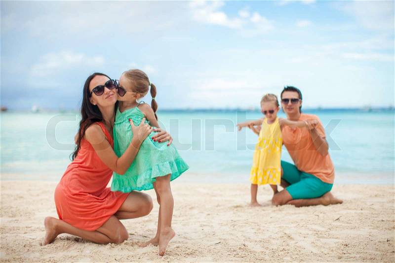 Young beautiful family with two kids on tropical vacation, stock photo