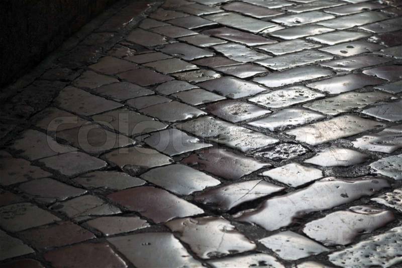Old shining stone pavement surface background, stock photo