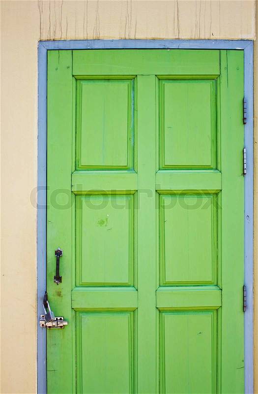 Green door closed with lock, stock photo