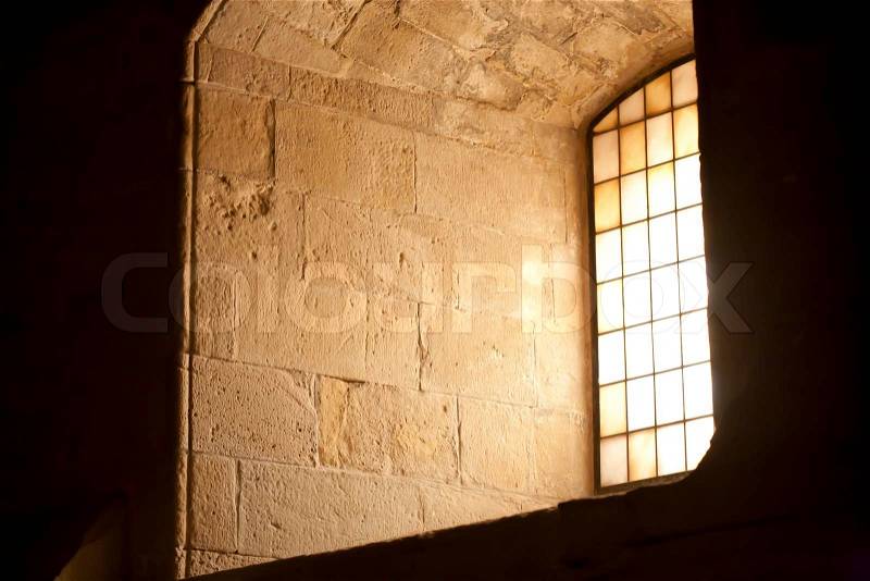 Dim light of a window of a medieval church, stock photo